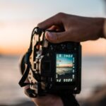 person holding black dslr camera