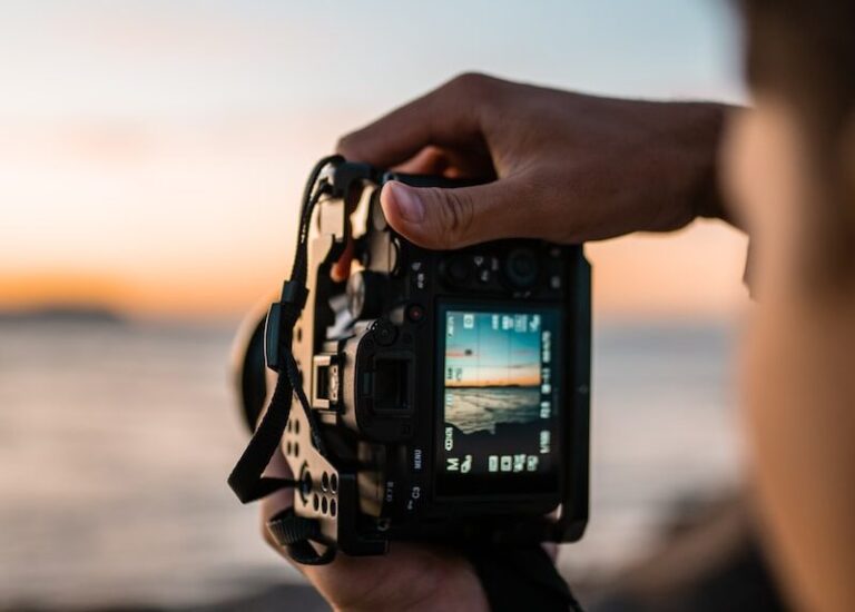 person holding black dslr camera